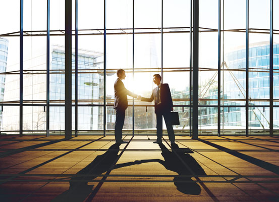 Photo of two business people shaking hands